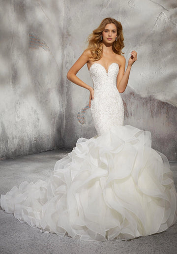 Ivory mermaid wedding dress with strapless sweetheart neckline, lace appliqué bodice, cascading ruffle skirt and dramatic train by Vedress