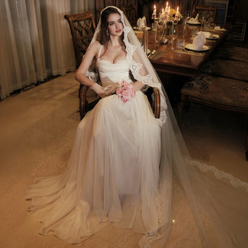 Ivory A-line wedding dress with square neckline slim straps fitted bodice and flowing floor-length skirt by Vedress