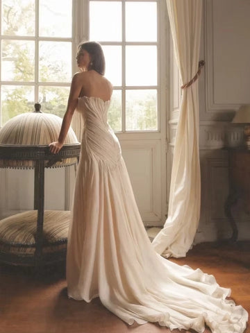 Back view ivory wedding dress with pleated fitted bodice and soft sweeping train