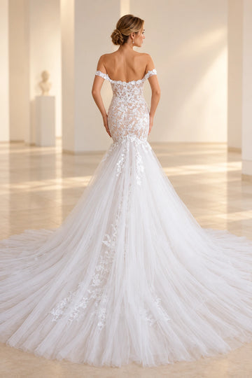Back view of Vedress mermaid wedding dress featuring a low scoop back, sheer lace bodice, cascading floral appliques and a wide tulle train.