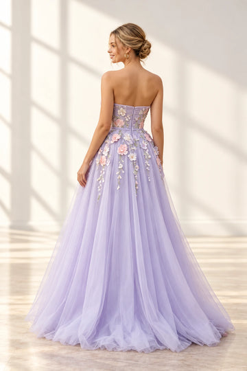 Back view of a Vedress lavender prom dress with a strapless floral bodice, center-back zipper and cascading flower appliqués over a full tulle skirt.