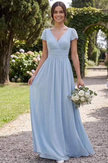 Light blue A-line bridesmaid dress with V-neckline, cap sleeves, gathered crossover bodice, ruched waistband, and flowing floor-length skirt by Vedress.