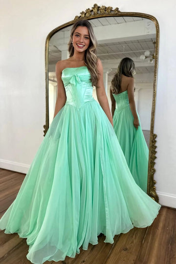Mint green strapless floor-length prom dress with bow detail and structured corset bodice