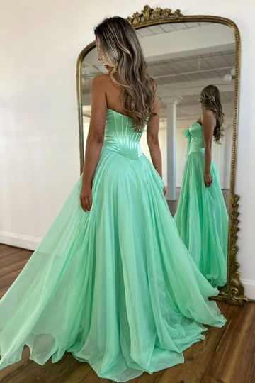 Mint green ball gown prom dress with corset-style back and flowing full skirt
