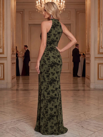 Olive green halter mermaid evening gown featuring a high-coverage back, black floral pattern, fitted waist and floor-length flared skirt, back view.