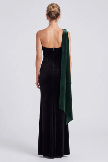 Back view of Vedress velvet evening dress with a low back, center zipper and a long emerald green panel falling from one shoulder.