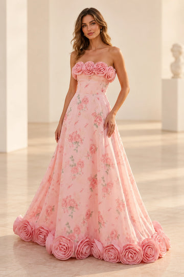 Front view of a Vedress pink floral A-line prom dress with a strapless bodice and oversized 3D roses along the neckline and floor-length hem.