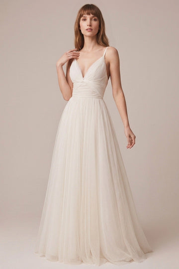 Ivory tulle A-line wedding dress with plunging V neckline, spaghetti straps, ruched bodice and flowing floor-length skirt front view