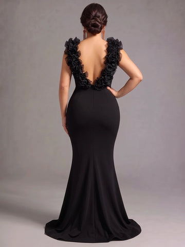Back view of Vedress black mermaid evening dress with a deep ruffled V-back, center zipper, and sweep train.