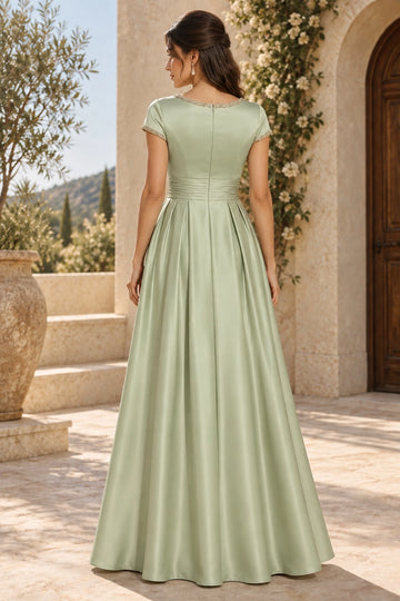 Back view of sage green mother of the bride dress featuring round neck, decorative trim, center zipper, ruched waistband and flowing A-line skirt