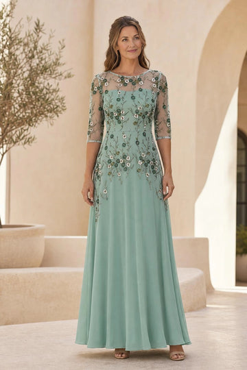 Sage green A-line mother of the bride dress with floral embroidery, sheer illusion round neckline, three-quarter sleeves and floor-length skirt, front view.