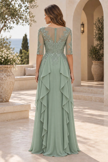 Back view of sage green mother of the bride dress featuring floral lace illusion back, center zipper, embroidered waist and floor-length ruffled skirt
