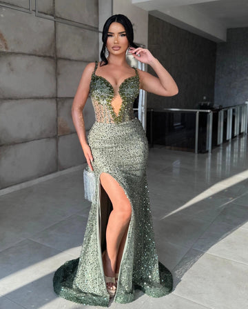 Sage green sequin mermaid prom dress with a plunging V-neckline, embellished shoulder straps, sheer beaded bodice, thigh-high slit and sweep train.