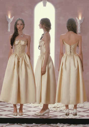Mirror view of Vedress satin A-line prom dress showing a strapless lace-trimmed neckline, front lacing and full pleated skirt.