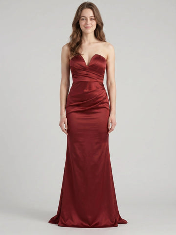 Front view of a burgundy satin Vedress wedding guest dress with a strapless sweetheart neckline, pleated bodice and floor-length trumpet skirt.