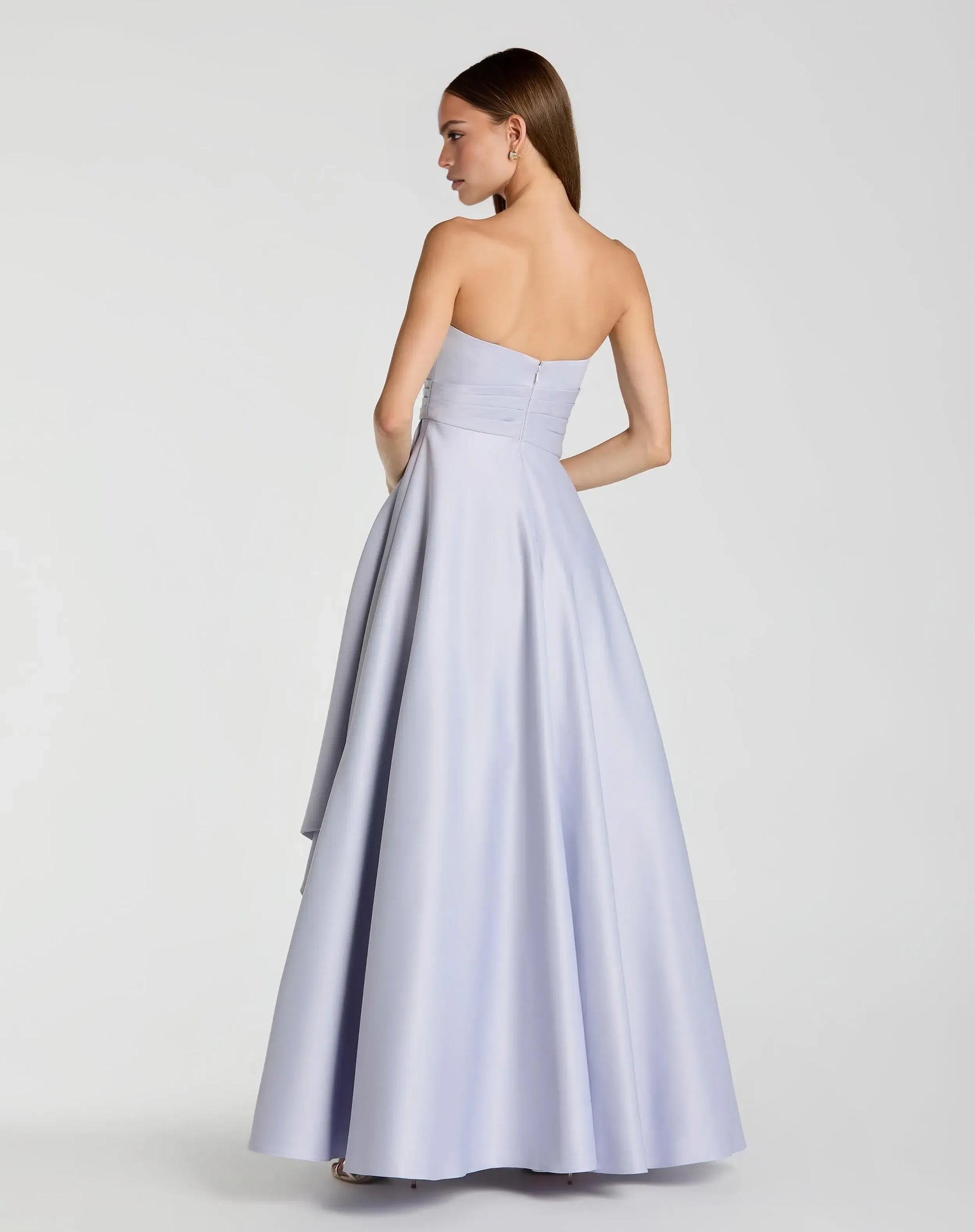Open-back strapless A-line formal gown with zipper closure, pleated waist, and flowing satin skirt by Vedress
