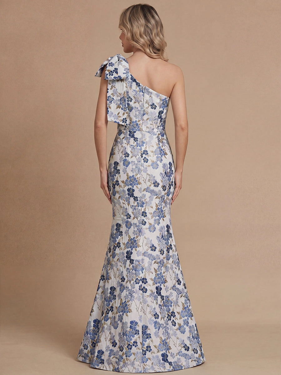 Vedress floral mermaid mother bride gown back view,one‑shoulder bow,hidden center back zipper,all‑over blue floral jacquard fabric,solid tan backdrop