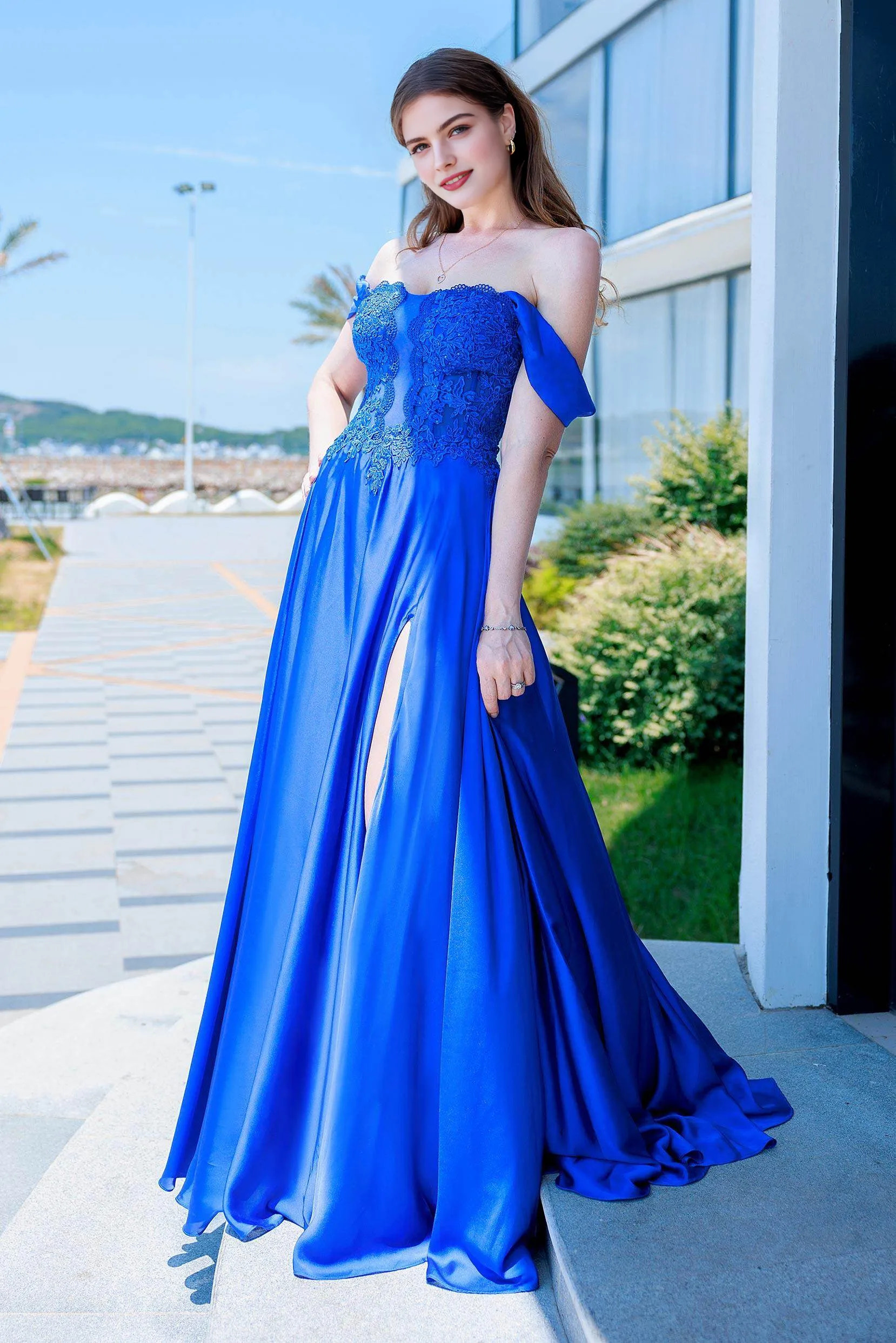 A-line prom gown with sweetheart neckline, off-shoulder draped sleeves, appliqué bodice, and flowing skirt with slit