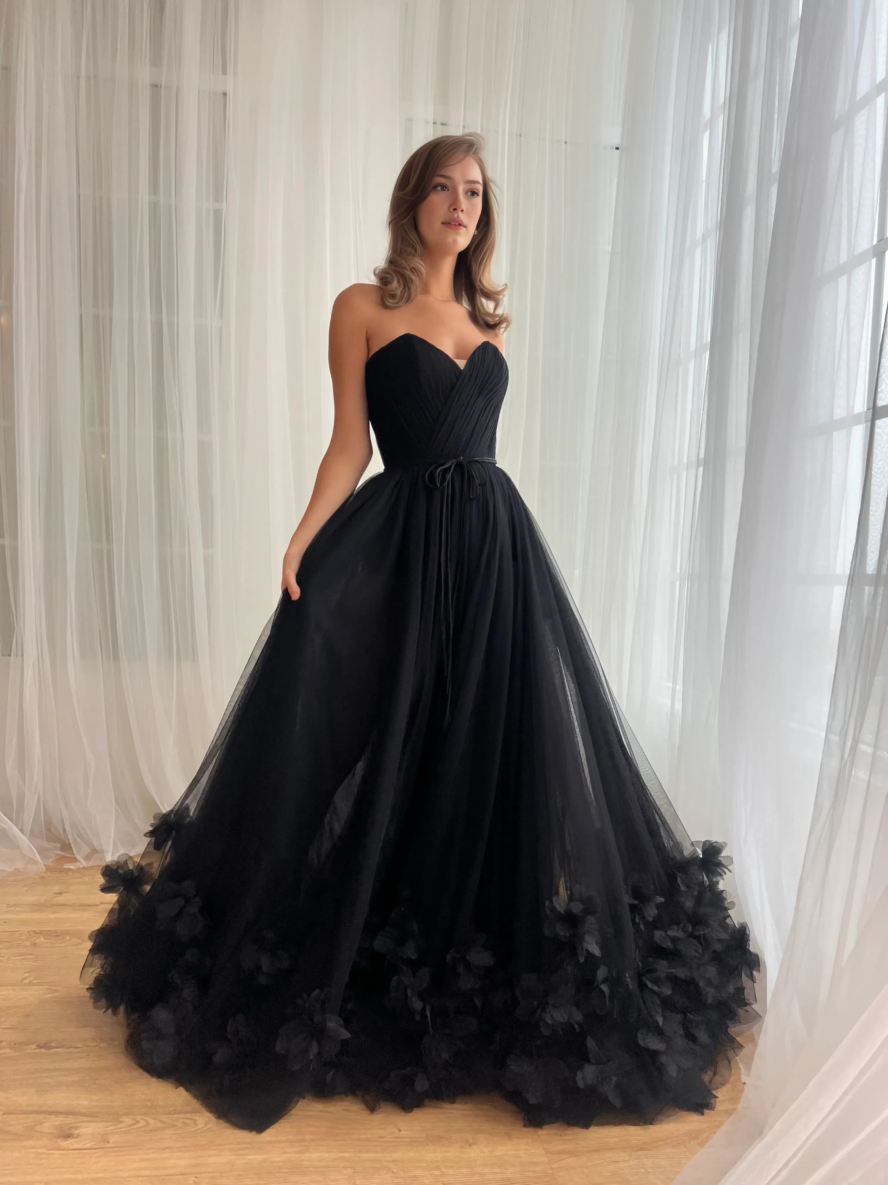 strapless sweetheart tulle prom gown with pleated bodice, tie waist, and 3D floral hem