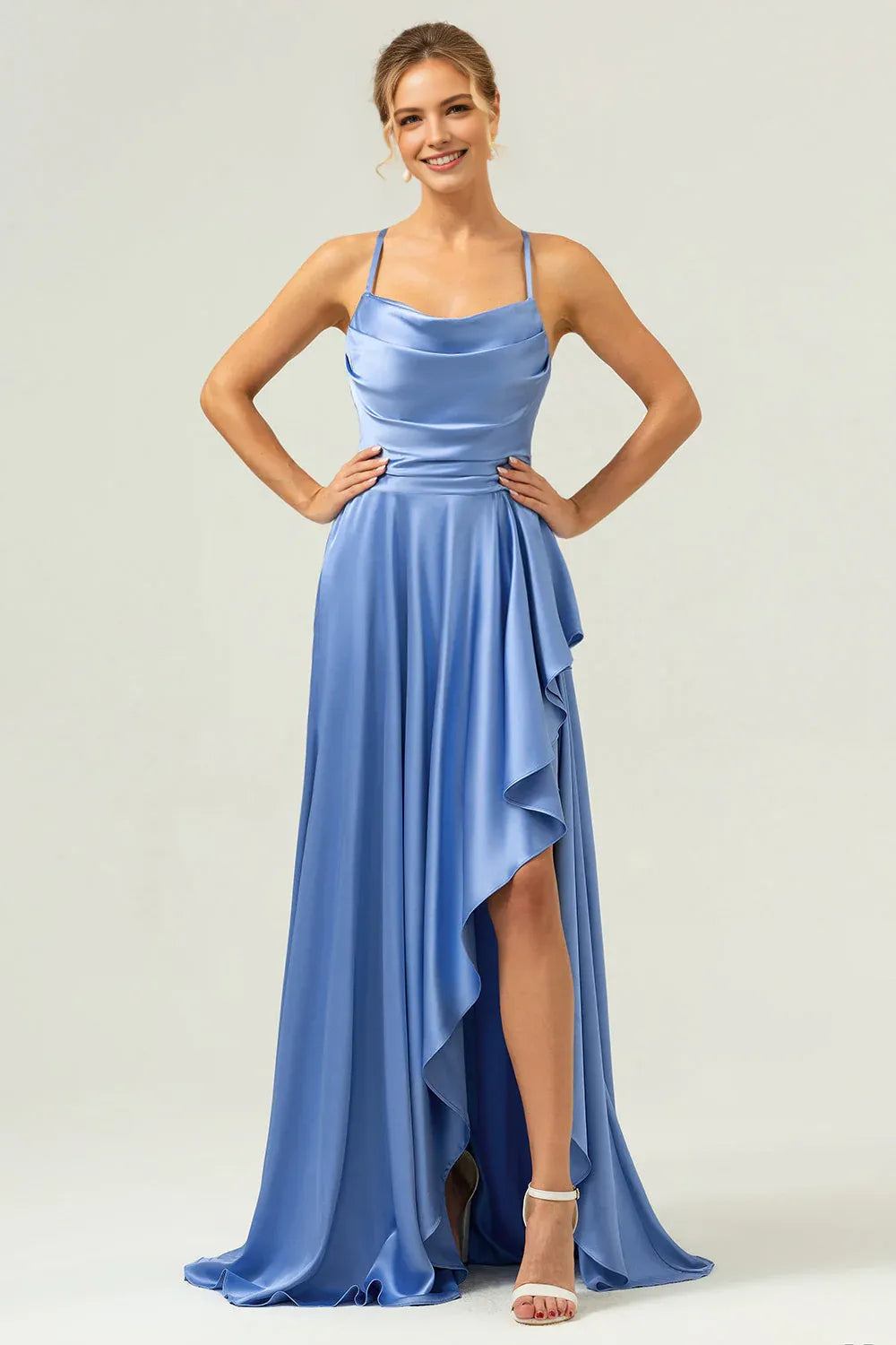 A-line satin evening gown with cowl neckline, spaghetti straps, cascading ruffle detail, and front slit