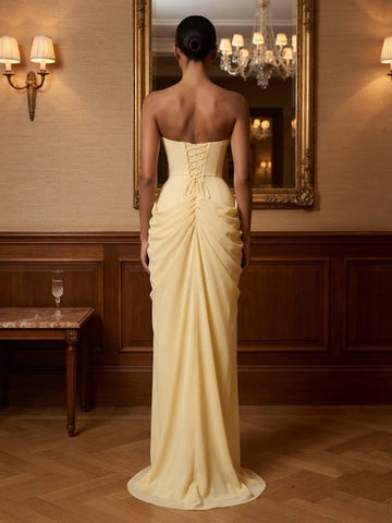 Model wearing vedress pale yellow draped prom dress corset lace‑up back mermaid long gown rear view