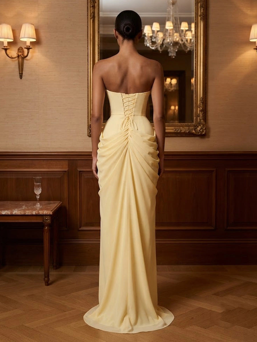 Model wearing vedress pale yellow draped prom dress corset lace‑up back mermaid long gown rear view