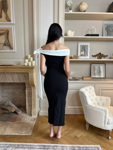 Black wedding guest dress with white off shoulder bow back detail