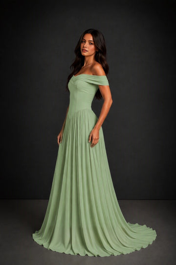 Back view of Vedress sage green bridesmaid dress with crisscross corset lacing, a waist bow and a flowing floor-length skirt.