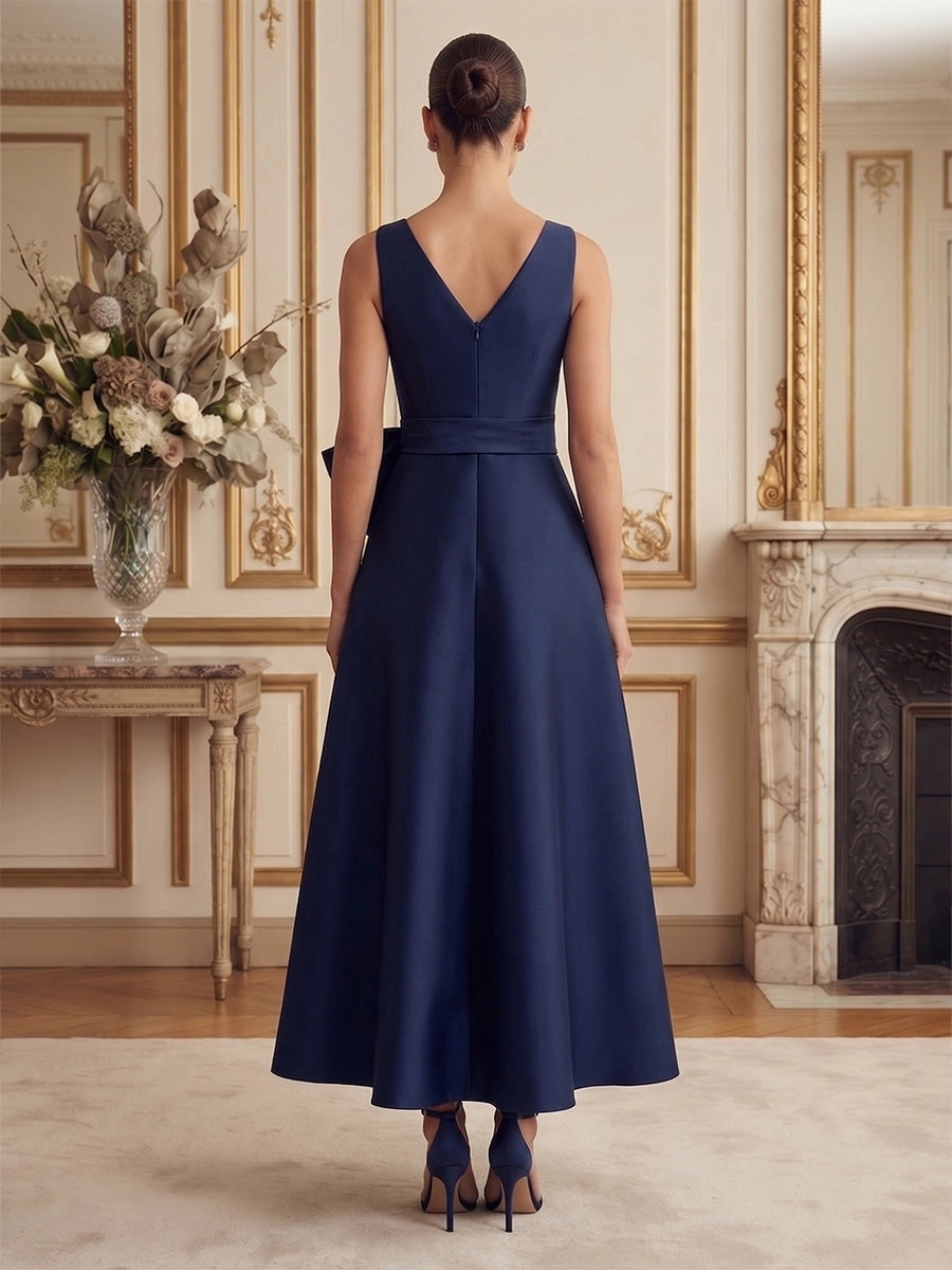Model wearing vedress navy midi mother dress v back invisible zipper waist bow rear view