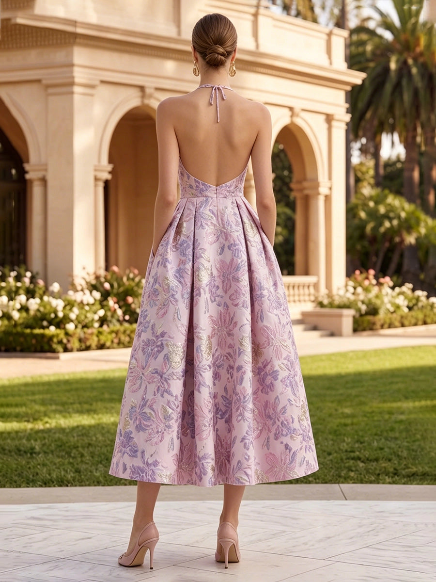 Model wearing vedress pink halter jacquard wedding guest dress deep open tie back midi rear view