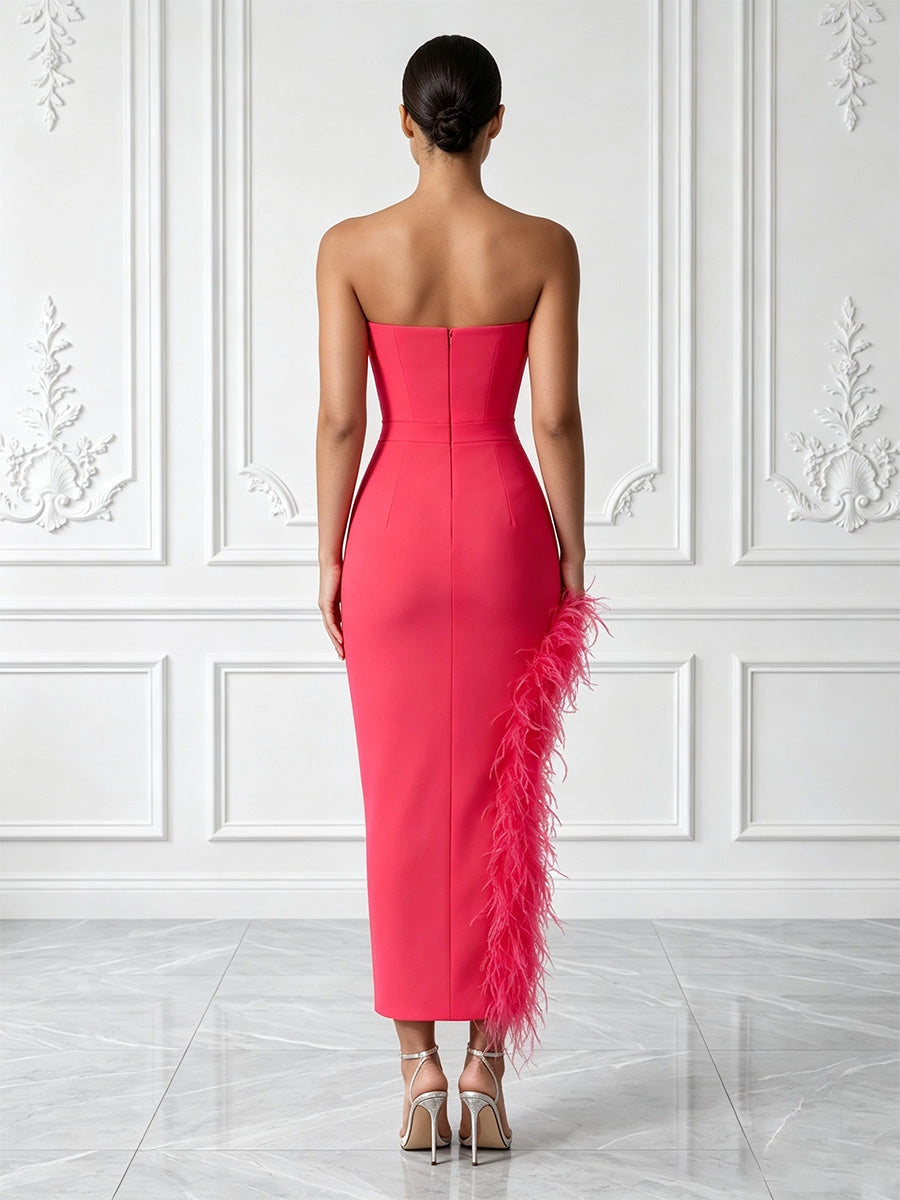 Model wearing vedress hot pink strapless midi prom dress invisible zip back feather slit rear view