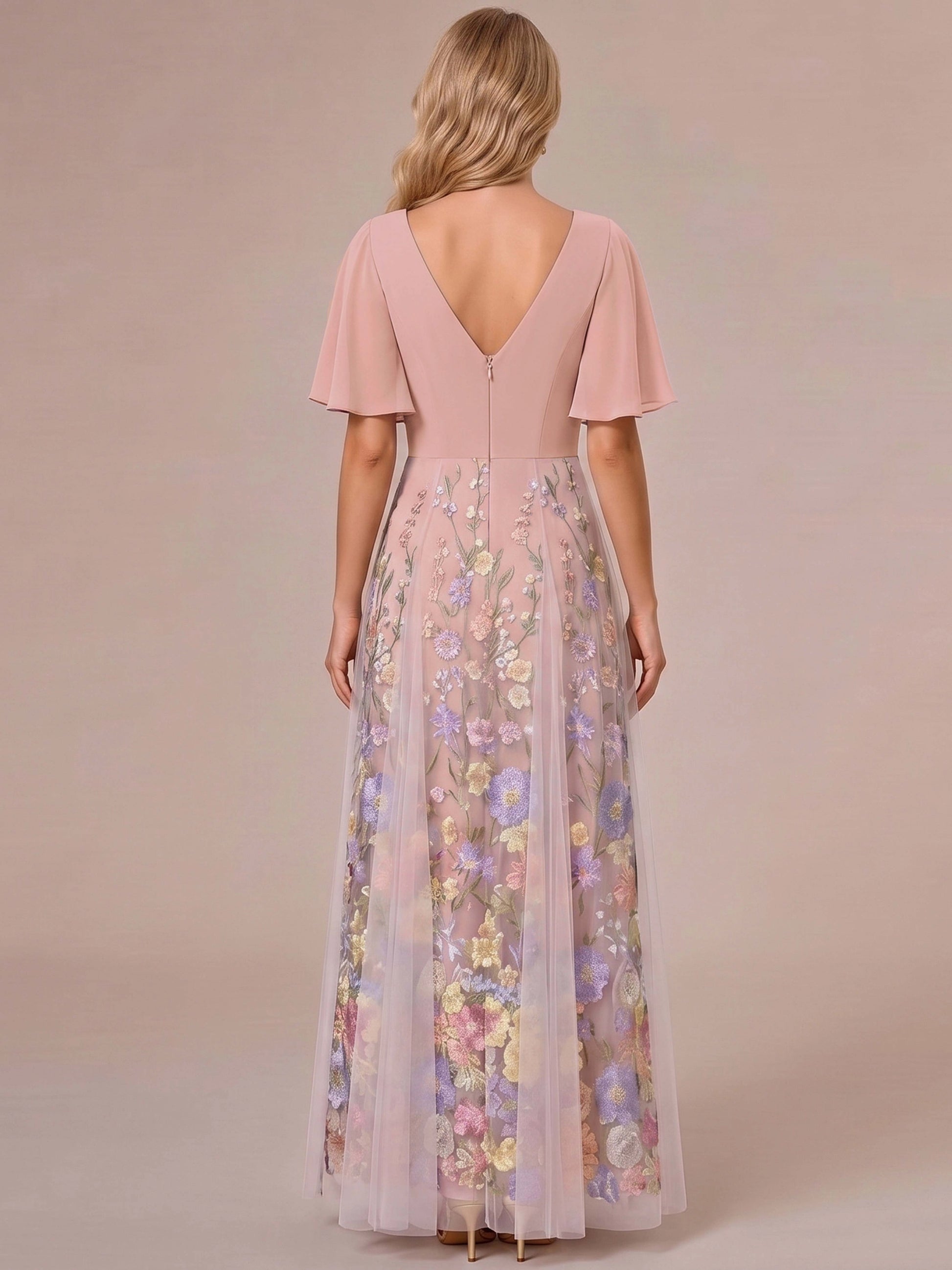 Model wearing vedress dusty pink embroidered mother of bride dress deep v back long formal gown rear view