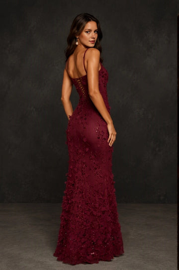 Back view of Vedress burgundy mermaid prom dress featuring a low lace-up back and floral appliqués along the flared skirt.
