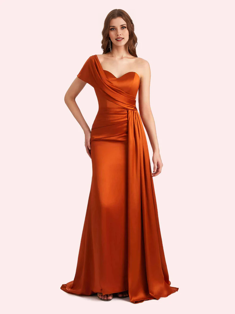 Burnt orange one-shoulder satin bridesmaid gown with sweetheart bodice, ruched waist, side drape, and floor-length sheath skirt by Vedress