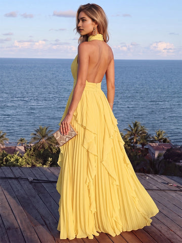 Vedress yellow chiffon prom gown back view,deep open back,halter tie closure,invisible zipper,flowy ruffle floor‑length skirt,ocean view scenery