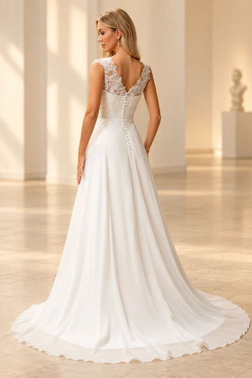 Back view of Vedress wedding dress showing a lace-framed V-back, covered buttons and a flowing floor-length chiffon skirt with train.