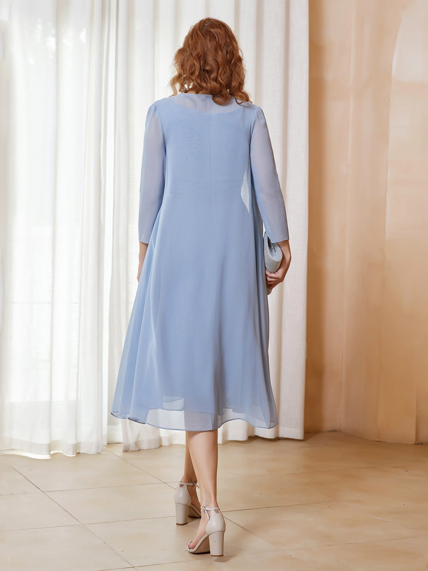 Back view of midi chiffon mother of the groom dress with three-quarter sleeves, smooth back design, flowing A-line skirt, and elegant formal fit by VEDRESS