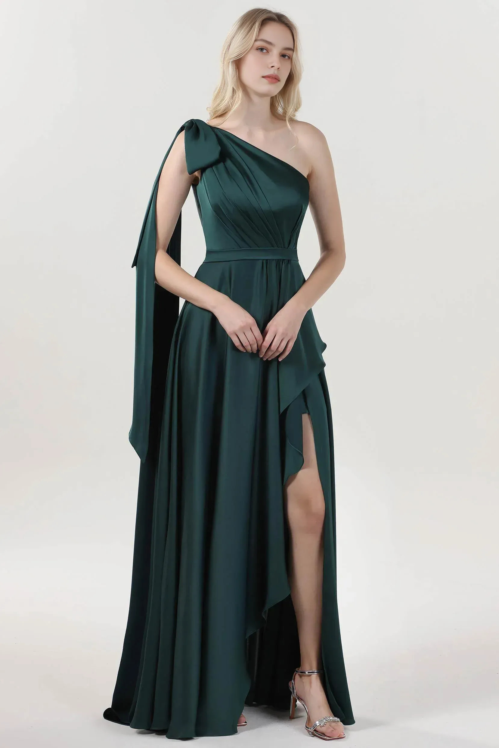 one-shoulder satin evening gown with bow-sash detail, pleated bodice, and thigh-high slit