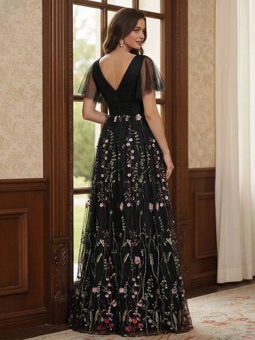 Model wearing vedress black floral embroidered mother of bride dress deep v‑back long formal gown rear view