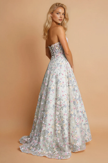 Back view of floral strapless tulle prom gown with lace-up corset back, full A-line skirt, soft train, and embroidered formal design by VEDRESS