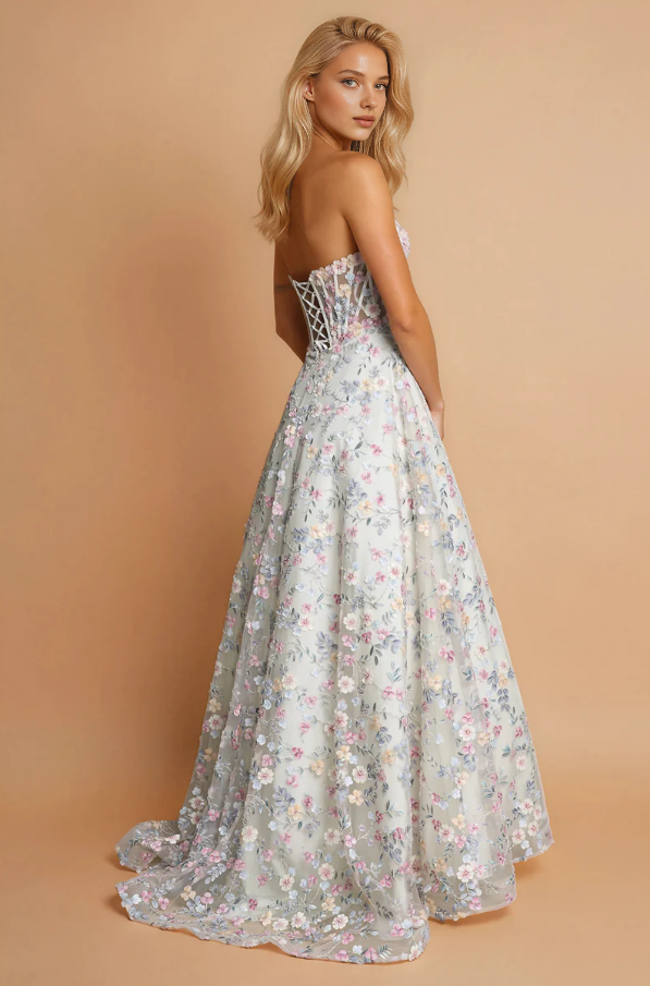 Back view of floral strapless tulle prom gown with lace-up corset back, full A-line skirt, soft train, and embroidered formal design by VEDRESS