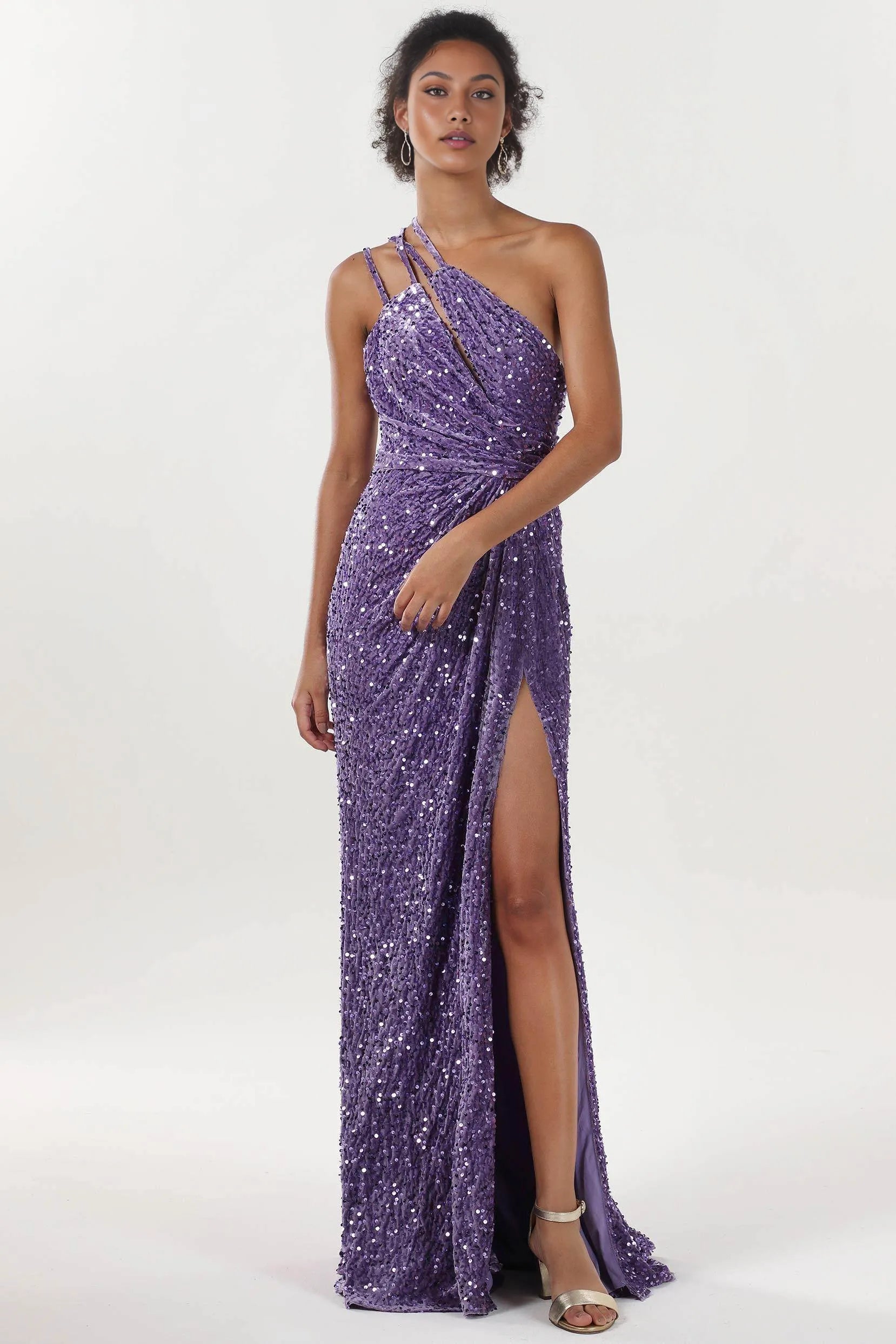 One-shoulder sequin evening gown with asymmetrical straps, ruched bodice, and front slit