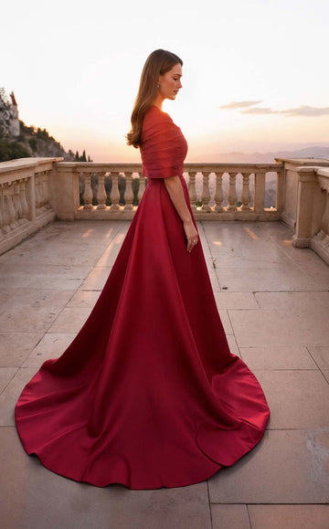 Back view of a burgundy A-line wedding guest dress showing its exposed upper back and center-back zipper