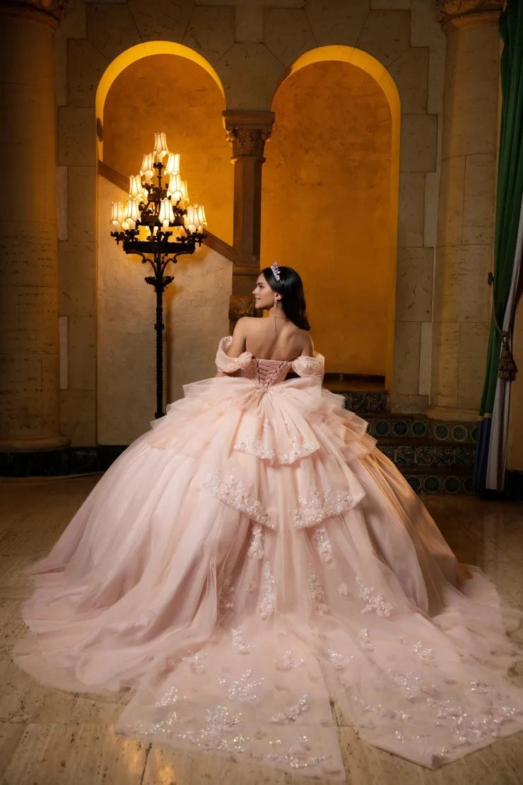 Vedress blush pink tulle quinceanera gown off shoulder puff sleeves lace-up corset back layered big bow full skirt with long train 3D flower appliques back view