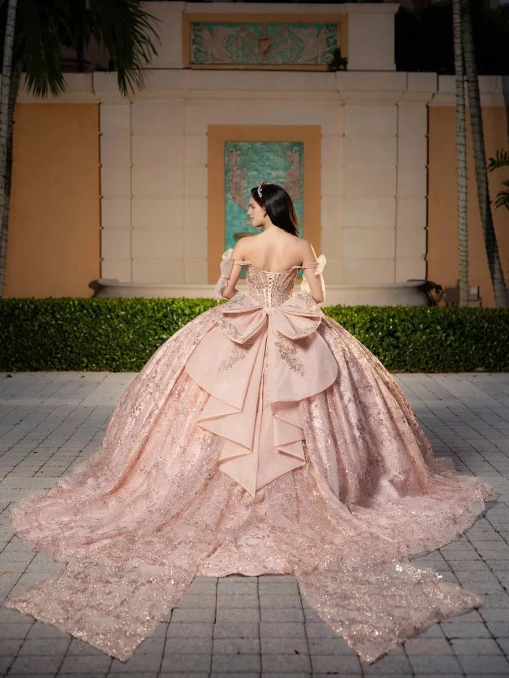 Vedress blush pink tulle quinceanera gown off shoulder tulle bow straps lace-up corset back oversized layered bow full skirt with long train glitter lace appliques back view