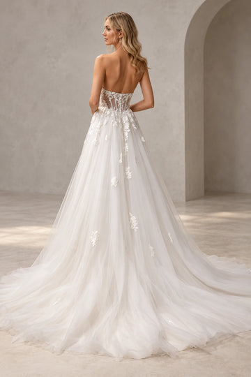 Back view of Vedress tulle wedding dress showing a low sheer corset-style back, floral lace appliques and a sweeping A-line train.