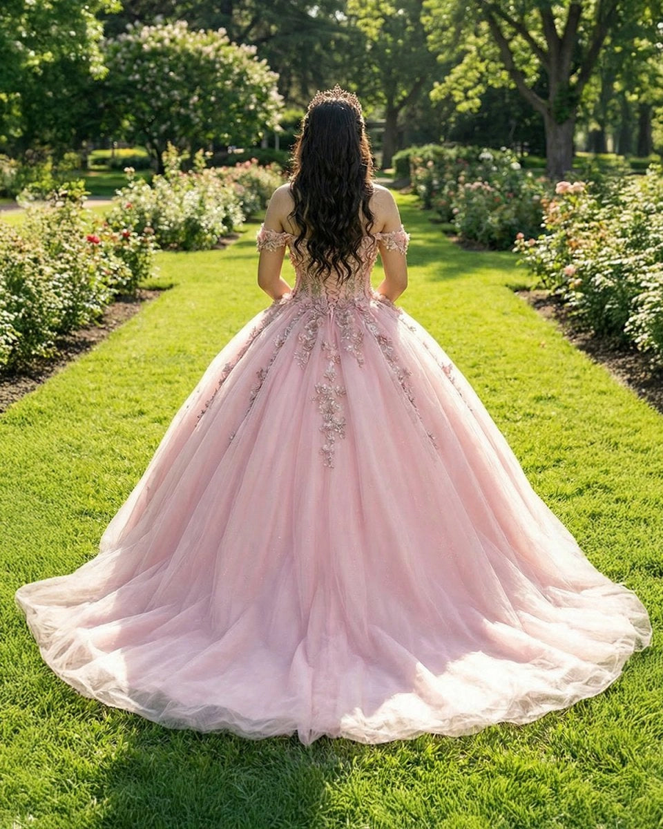 Vedress blush pink quinceanera ballgown back view, lace-up corset back, sweep train tulle skirt decorated with cascading 3D flower appliques