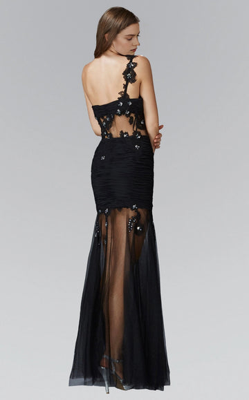 Back view of a black prom dress showing its floral shoulder strap, open upper back and sheer floral waist panel