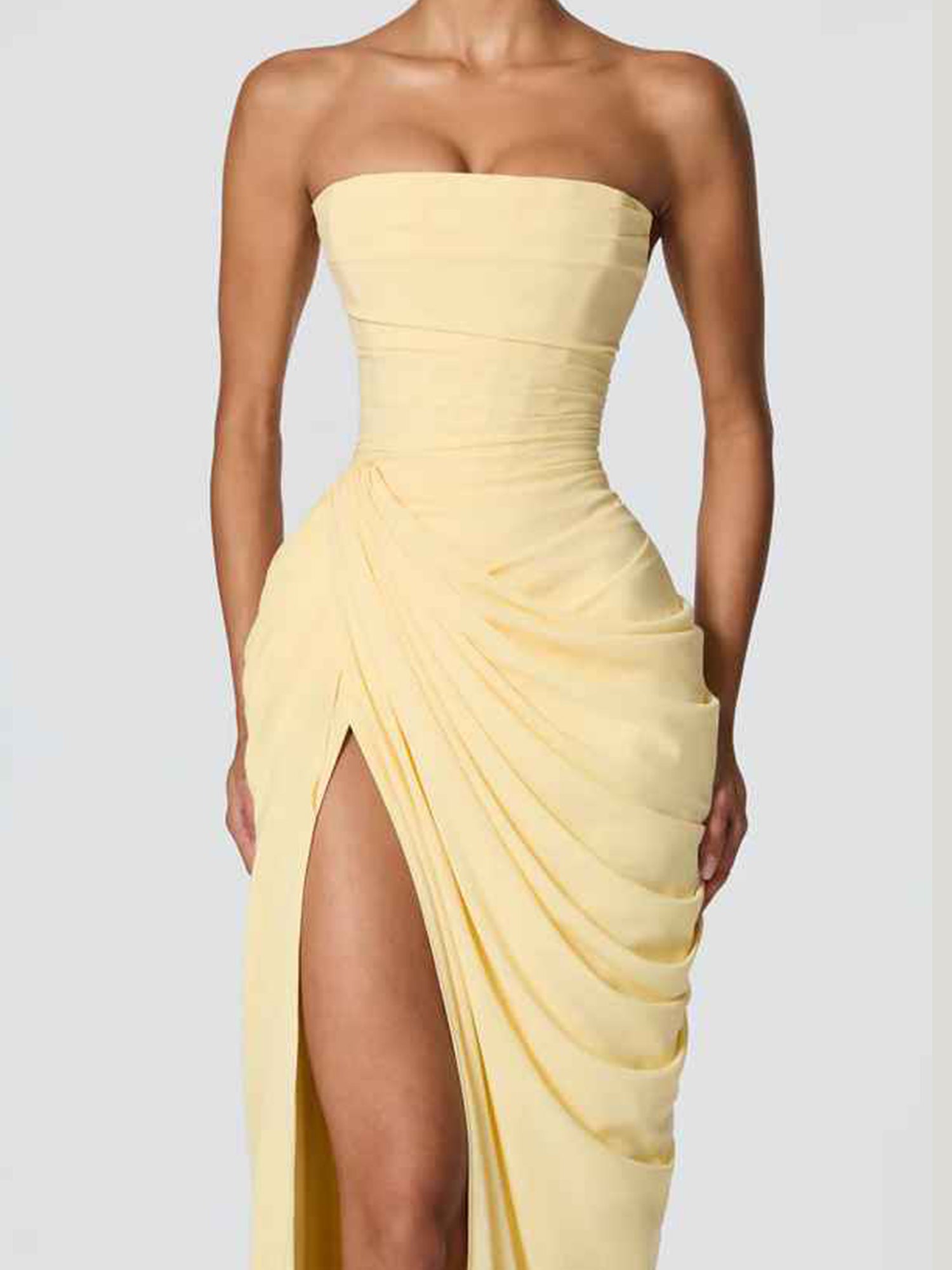 Strapless ruched sheath formal gown with high slit, sleeveless bodice, and draped skirt detail by Vedress