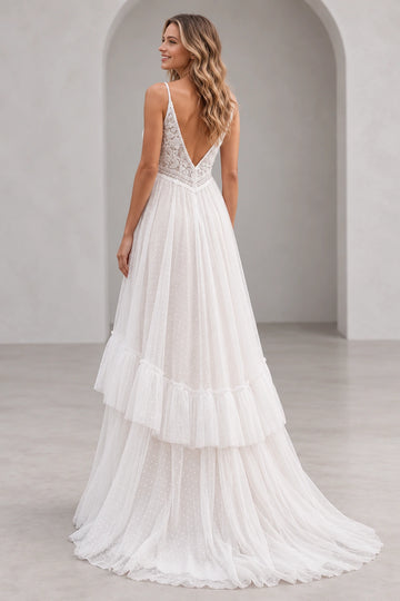 Back view of Vedress wedding dress with deep V-back, floral lace waist detail and dotted tulle skirt with a ruffle tier and short train.